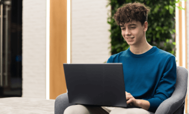 Man working on a laptop, illustrating various fields such as education, and research utilizing academic translation services.
