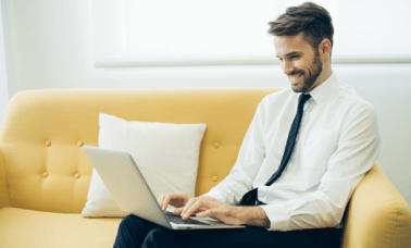 Translator working on a laptop, representing professional academic translation services available in major cities.
