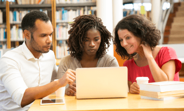 A group of students reviewing translated academic documents, highlighting the importance of expert academic translations