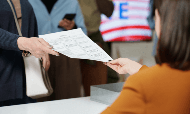 A professional handing over a translated CV, emphasizing accurate and CV translation services for career advancement.
