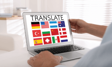 A collection of international flags on screen, representing CV translation services available in various languages.