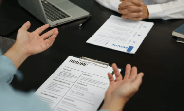 Translators discussing documents, illustrating a seamless efficient CV translation ordering process for hassle-free service.